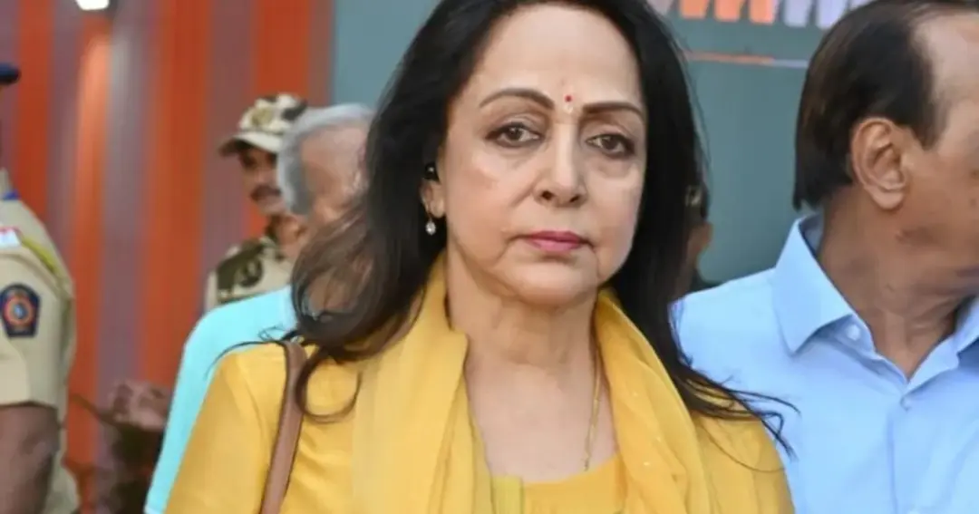 Hema Malini with an elderly person at the polling booth.